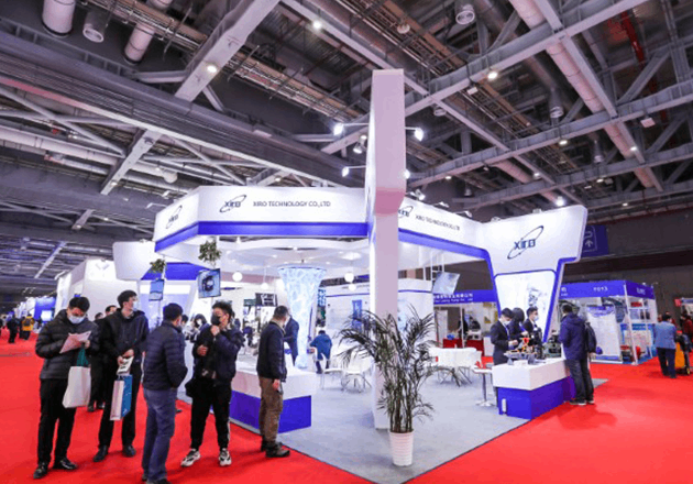 XIRO engineering specialists consulting with clients at international press machinery trade show